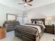 A primary bedroom offers a ceiling fan, dresser, and nightstands at 11624 Peach Grove Ln, Orlando, FL 32821