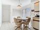 A dining area shows a table with neutral colored chairs and access to a pantry at 11624 Peach Grove Ln, Orlando, FL 32821