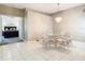 Dining room with tile flooring, chandelier, and views into an adjacent bedroom at 11624 Peach Grove Ln, Orlando, FL 32821