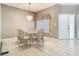 Inviting dining room with classic chandelier and natural light from a window at 11624 Peach Grove Ln, Orlando, FL 32821