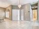 Bright entryway with chandelier, tile floors, and clear view into the bathroom, setting a welcoming tone at 11624 Peach Grove Ln, Orlando, FL 32821