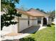 Charming home exterior showcasing neutral paint, desert landscaping and paved walkway at 11624 Peach Grove Ln, Orlando, FL 32821