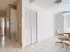 Hallway featuring neutral tones, tiled floors, and doors to various rooms in the home at 11624 Peach Grove Ln, Orlando, FL 32821