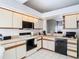 Functional kitchen with tile floor, white appliances, and white cabinets is ready for new owners at 11624 Peach Grove Ln, Orlando, FL 32821