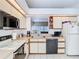 Functional kitchen with tile floor, white appliances, and white cabinets is ready for new owners at 11624 Peach Grove Ln, Orlando, FL 32821