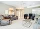 Cozy living room featuring neutral walls, plush carpeting, ceiling fan, and arched entryways at 11624 Peach Grove Ln, Orlando, FL 32821