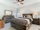 Comfortable main bedroom with a ceiling fan, nice furniture, and natural light at 11624 Peach Grove Ln, Orlando, FL 32821