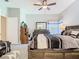 Tranquil main bedroom featuring neutral walls, ceiling fan, a large bed, and ample natural light at 11624 Peach Grove Ln, Orlando, FL 32821