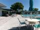 Enjoy the community pool with lounge chairs and umbrellas on a sunny day at 11624 Peach Grove Ln, Orlando, FL 32821