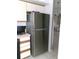 Stainless steel refrigerator adds a modern touch to the kitchen space with views to the dining area at 11624 Peach Grove Ln, Orlando, FL 32821