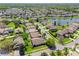 Aerial view of a quiet neighborhood surrounding a small lake features beautiful houses and mature trees at 124 Windsor Cresent St, Winter Springs, FL 32708