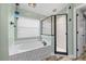 Bathroom featuring a soaking tub, a glass-enclosed shower, and a blue pendant light fixture at 124 Windsor Cresent St, Winter Springs, FL 32708