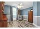 Cozy bedroom featuring blue accent walls, wood floors, and a comfortable armchair at 124 Windsor Cresent St, Winter Springs, FL 32708