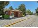 The guard house at the entrance to the brick paved gated community is surrounded by mature landscaping at 124 Windsor Cresent St, Winter Springs, FL 32708