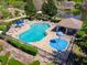 Aerial view of a community pool and splashpad, complete with ample seating and a covered shelter at 124 Windsor Cresent St, Winter Springs, FL 32708