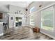 Bright dining room with hardwood-style flooring, vaulted ceilings, and sliding glass door to backyard at 124 Windsor Cresent St, Winter Springs, FL 32708