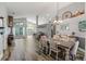 Bright dining area boasts hardwood-style floors, chandelier, and open concept living space at 124 Windsor Cresent St, Winter Springs, FL 32708