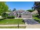 Charming single-story home featuring a well-manicured lawn, two-car garage, and neutral gray exterior at 124 Windsor Cresent St, Winter Springs, FL 32708