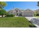 Charming single-story home featuring a well-manicured lawn, two-car garage, and neutral gray exterior at 124 Windsor Cresent St, Winter Springs, FL 32708