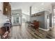 Living area featuring hardwood-style floors, piano, bar seating, and neutral color palette at 124 Windsor Cresent St, Winter Springs, FL 32708