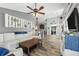 Bright living room featuring a comfortable sectional sofa, wood-look flooring, and stylish decor at 124 Windsor Cresent St, Winter Springs, FL 32708