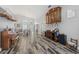 Open living area with wood-look flooring, vaulted ceilings, and decorative vintage cabinet and piano at 124 Windsor Cresent St, Winter Springs, FL 32708