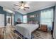 Cozy main bedroom with blue walls, wood-look flooring, and decorative accents at 124 Windsor Cresent St, Winter Springs, FL 32708