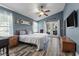 Inviting main bedroom showcasing tray ceiling, ceiling fan, wood-look tile floors, and private doors at 124 Windsor Cresent St, Winter Springs, FL 32708