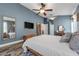 Main bedroom featuring blue walls and wood-look floors, leading to the ensuite bathroom at 124 Windsor Cresent St, Winter Springs, FL 32708