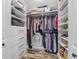 Walk-in closet with custom shelving, hanging rods, and drawer units for optimal storage at 124 Windsor Cresent St, Winter Springs, FL 32708