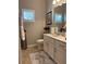 Half bathroom featuring single sink vanity, framed mirror, and neutral tones at 1247 Travertine Ter, Sanford, FL 32771