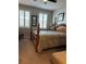 Inviting bedroom featuring a wooden bed frame and shuttered windows at 1247 Travertine Ter, Sanford, FL 32771