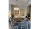 Dining area with a modern chandelier, wood table, and stylish decor at 1247 Travertine Ter, Sanford, FL 32771