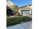 Charming home exterior featuring a well-manicured lawn, inviting landscaping, and a two-car garage at 1247 Travertine Ter, Sanford, FL 32771