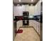 Kitchen featuring stainless steel appliances, white cabinetry, and dark counter tops at 1247 Travertine Ter, Sanford, FL 32771