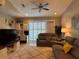 Comfortable living room with plush sofas, ceiling fan, and access to outdoor space at 1247 Travertine Ter, Sanford, FL 32771