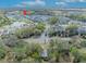 Aerial view of townhouse community, pond, pool and green space from above the tree line at 1312 Painted Bunting Ave, Oakland, FL 34787