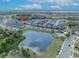 Beautiful aerial view of townhouse community with lake, green space, and community pool at 1312 Painted Bunting Ave, Oakland, FL 34787