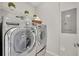 Laundry room featuring modern washer and dryer set with shelving at 1312 Painted Bunting Ave, Oakland, FL 34787