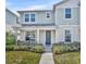 Charming two-story home featuring a well-manicured lawn, gray door and blue siding at 1312 Painted Bunting Ave, Winter Garden, FL 34787