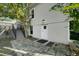 View of house exterior with brick paved yard and stairs leading to fenced backyard and basement door at 1407 E Kaley St, Orlando, FL 32806