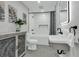 Charming bathroom featuring hexagon tile floors, a console sink, and modern white subway tile in the shower at 1407 E Kaley St, Orlando, FL 32806