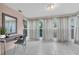 Entryway featuring tiled floors, a desk and chair, a mirror, and three large windows at 1407 E Kaley St, Orlando, FL 32806