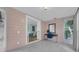 Entryway featuring views to the living room, tiled floors, a desk and chair, and windows at 1407 E Kaley St, Orlando, FL 32806