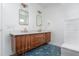 Modern bathroom with double sink vanity, geometric blue tile floor, and updated fixtures at 1432 W Yale St, Orlando, FL 32804