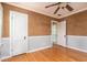 Bedroom with two doors, featuring hardwood floors and a ceiling fan at 1432 W Yale St, Orlando, FL 32804