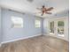 Bedroom with wood-look tile flooring, ceiling fan, and french door access to patio at 1432 W Yale St, Orlando, FL 32804