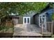 Exterior wooden deck with wooden railing and view of the home's backyard and siding at 1432 W Yale St, Orlando, FL 32804