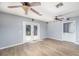 Large room with wood-look flooring, neutral paint, and French doors to the backyard deck at 1432 W Yale St, Orlando, FL 32804