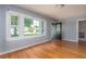 Bright living room with refinished hardwood floors, large windows, and freshly painted neutral walls at 1432 W Yale St, Orlando, FL 32804